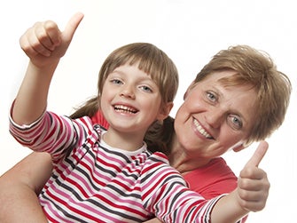 Grandmother with grandchild giving a 'thumbs up'